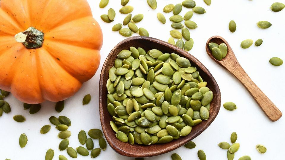 Pumpkin and a bowl of pumpkin seeds, the source of the pumpkin seed extract in Dermaworks lash and brow serums