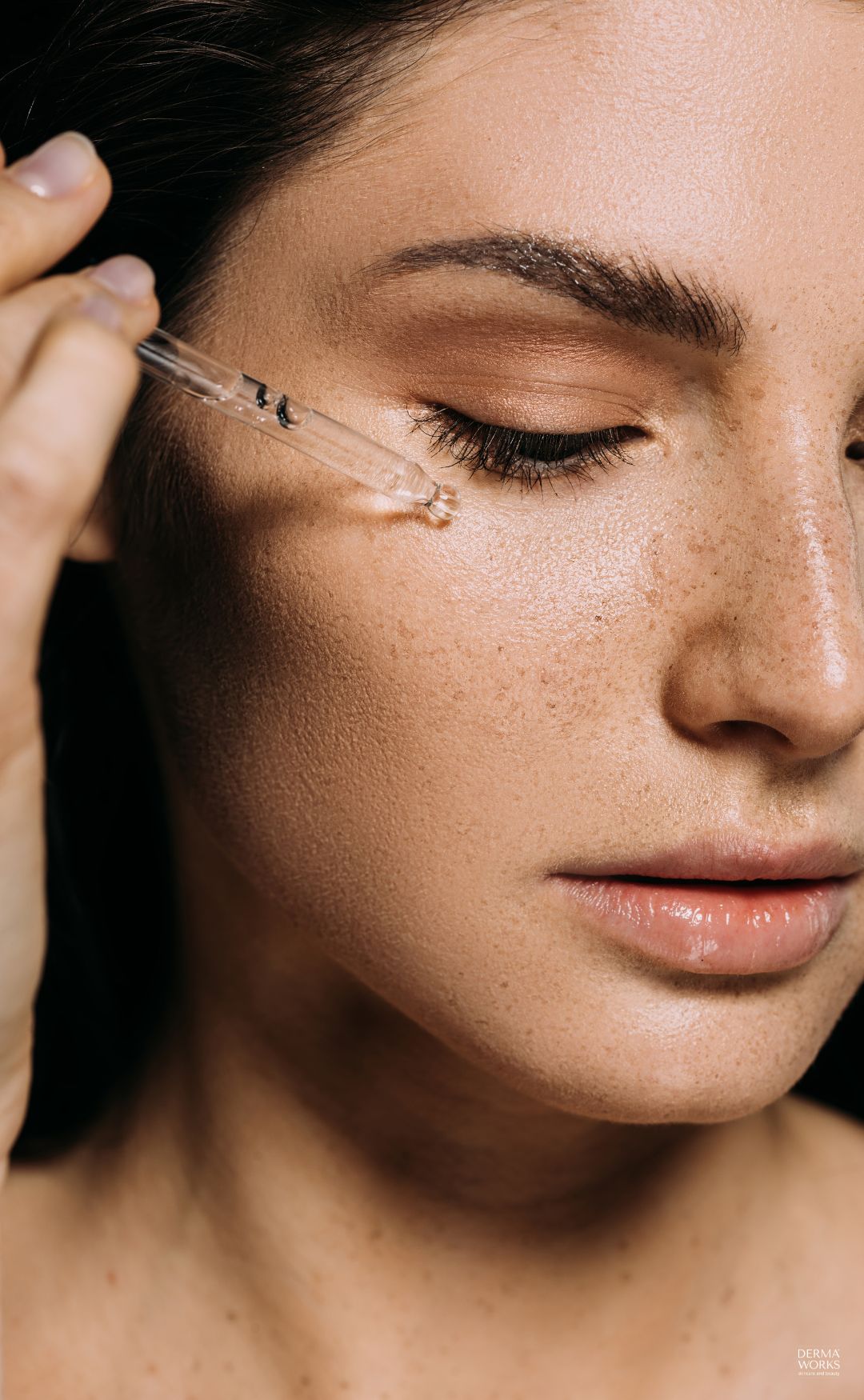 Woman_Applying_Vitamin_C_Serum_Before_Makeup.jpg